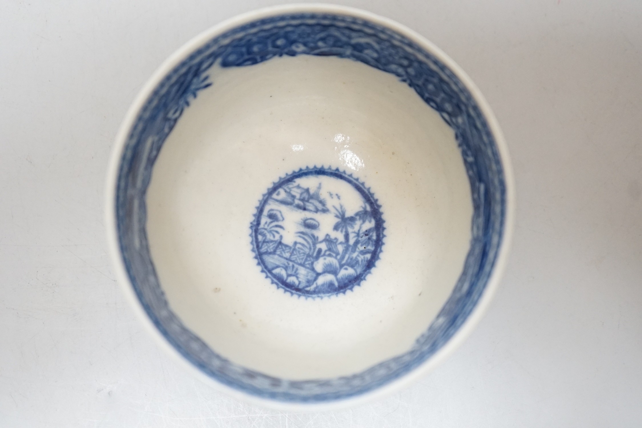 An 18th century Caughley teabowl and saucer printed with the uncommon Fence and House pattern. 6cm tall overall